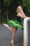 People in Choreography. Natural Portrait of Artistic Professional Caucasian Ballet Dancer in Green Tutu Dress Posing in Park