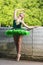 People in Choreography. Portrait of Sensual Dancing Professional Caucasian Ballet Dancer in Green Tutu Dress Posing in Park