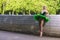 People in Choreography. Portrait of Sensual Dancing Professional Caucasian Ballet Dancer in Green Tutu Dress Posing in Park