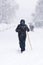 People on a city street covered in snow during heavy snowfall storm in Madrid