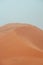 People climbing Erg Chebbi dunes in Sahara Desert, Merzouga, Morocco