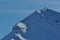 People climbing the ridge of a snowy mountain in Italian Alpes, with snowshoes or ski