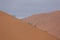 People climbing sand dune.