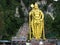 People climbing the stairs of the Batu Caves with the golden statue of Murugan. Malaysia