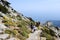 People climbing up mount Capanne on Elba island, Italy