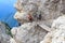 People climbing the Via Ferrata Severino Casara with bridge in Sexten Dolomites mountains, South Tyrol