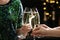 People clinking glasses of champagne on blurred background