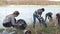 People collecting garbage near the lake