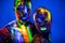 People are colored fluorescent powder. a pair of lovers dancing at a disco