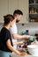 People cooking at home. Young couple preparing something healthy to eat.