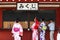 People in cotton yukata robes getting their `Mikuji` fortune at a shrine in Japan