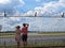 People Couple Guy and Girl in Love Together Looking Watching Planes at Airport through Fence with Barbed Wire