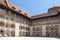 Without people courtyard with arcades at the Wawel Royal Castle in Krakow, Poland on a sunny summer day