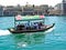 People cross the Dubai Creek between the districts of Deira and Bur Dubai aboard a traditional Abra water taxi