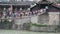 People crossing iron chain bridge