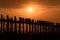 People crossing the longest teak bridge in the world, the iconic wooden U Bein Bridge during sunset, Mandalay, Myanmar