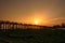 People crossing the longest teak bridge in the world, the iconic wooden U Bein Bridge during sunset, Mandalay, Myanmar