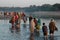 People crossing the river at Beneshwar fair, India