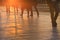 People crossing a road during sunset hours