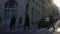 People crossing street, row of cars parked near buildings, Paris city life