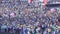 People crowd (football, soccer fans) on the square playing with balloon balls