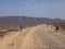 People cycling on a dirt path in the island of La Graciosa, Lanzarote, Canary Islands