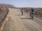 People cycling on a dirt path in the island of La Graciosa, Lanzarote, Canary Islands