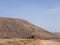 People cycling on a dirt path in the island of La Graciosa, Lanzarote, Canary Islands