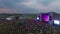 People dance at a music rock festival. Aerial view. Main stage.