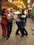 People dance a pair dance on a retro dance floor in the center of Lviv
