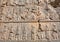 People on the destroyed stone bas-relief in Persepolis