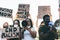 People from different ages and races protest on the street for equal rights - Demonstrators wearing face masks during black lives