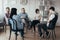 People of different ages sits in a circle during a meeting with a professional therapist