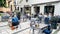 People dine on the open verandas of cafes and restaurants on the Bergs Bazaar district in Riga