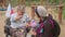 People with disabilities. Woman in wheelchair greets her friends at playground.