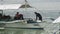 People divers on boat on background of green Pacific coast in Philippines.