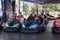 People on dodgem bumper car ride at amusement fair