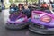 People on dodgem bumper car ride at amusement fair