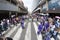 People dressed in purple in allusion to the Nazarene walking down a street in the center of Caracas