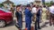 People dressed up in 1940\\\'s clothing posing in front of a World War 2, D-Day ceremony in Normandy, France