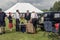 People dressed up in period costumes for a picnic with vintage cars, 1940s