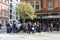 People drinking in front of a typical pub in the London city center