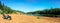 People driving ATV quads on sand beach at lake