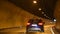 People driving car on the road passed mountain in car tunnel go to Italy