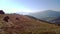 People driving quad bikes on mountain hill in summer.