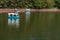 People in duck paddle boats in man made lake