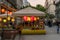 People eating dinner at an outdoor restaurant with colorful lamps in Budapest Hungary.