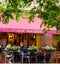 People eating outside at Cafe Brasserie as bars and restaurants