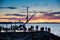 People on the embankment of the Icelandic capital Reykjavik are looking at the sunset