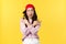 People emotions, lifestyle leisure and beauty concept. Cool and sassy stylish asian girl in red hip hop cap, showing